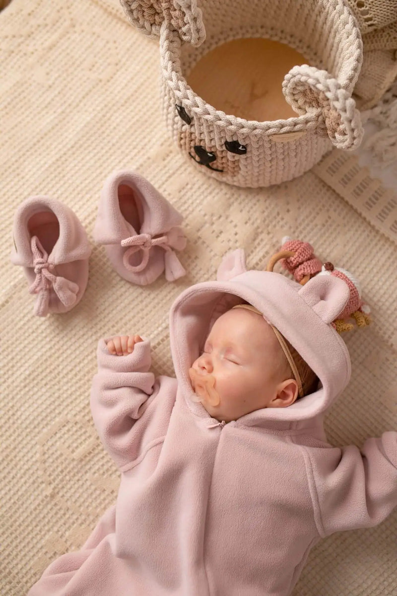 Baby girl in a soft pramsuit